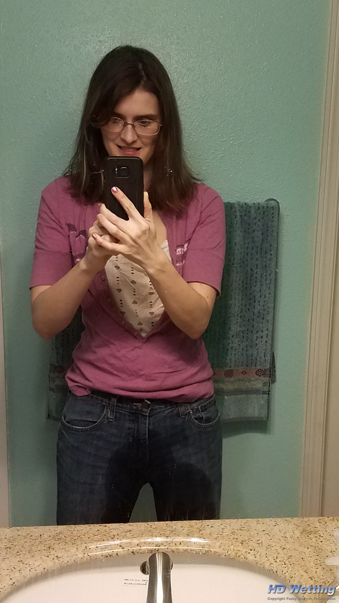 bathroom-171920 Sosha takes a selfie in the mirror in her wet, peed in pants.