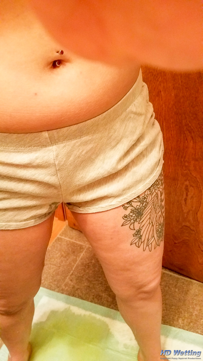 lyra-163902 Starting to pee in her shorts onto the bathroom floor