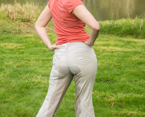 After peeing in her light colored pants, they become transparent making her panties visible.