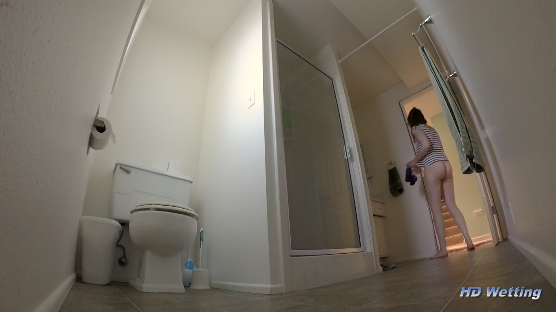 dribble-8 Leaving the bathroom, carrying her wet underwear in her hand.