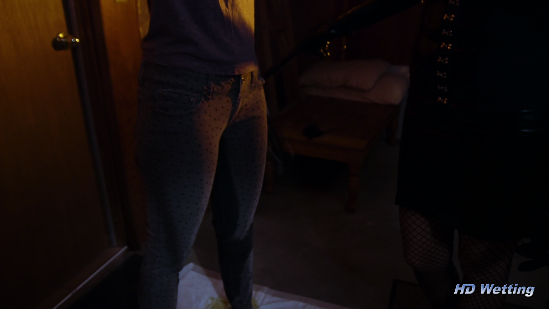 bondage-7 Sosha is standing wearing wet pants in the pee puddle she made on the floor