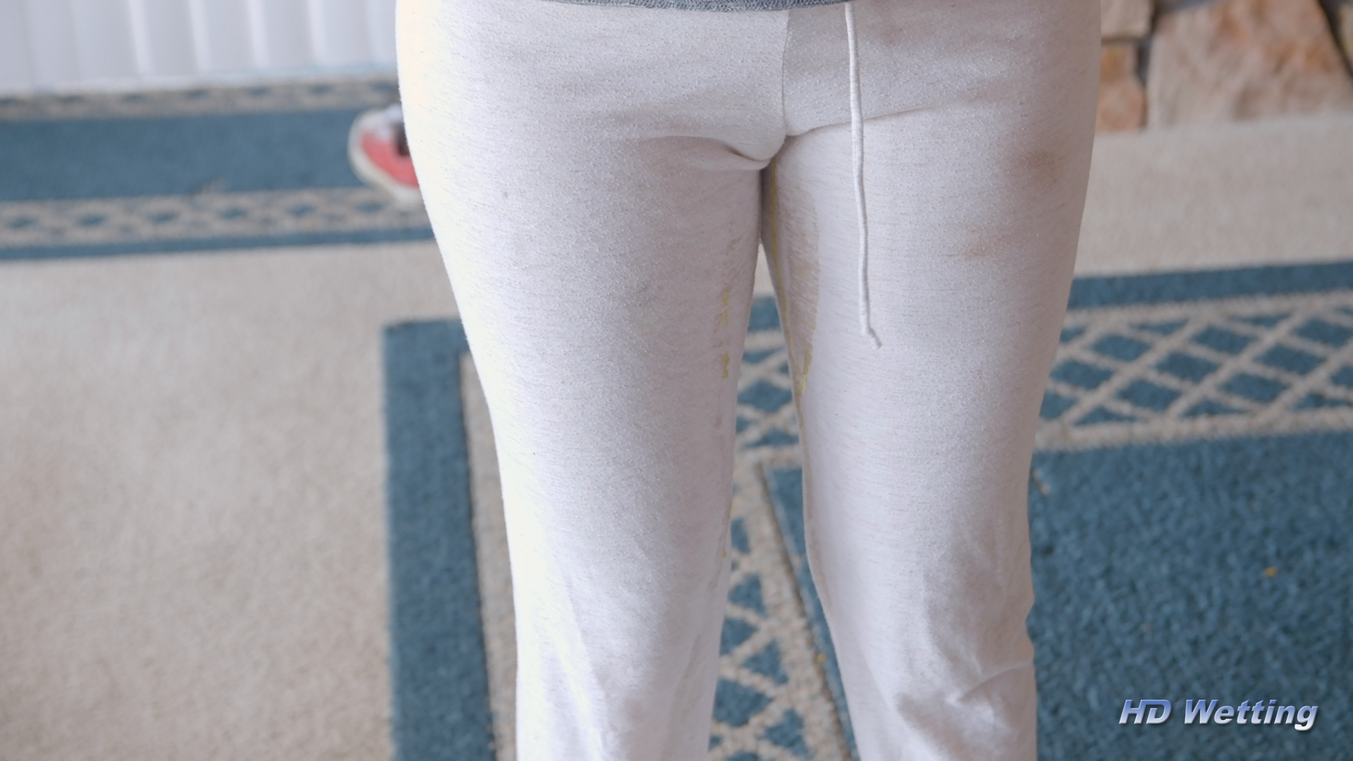 white-3 Wet streaks are just barely visible as Alisha starts to pee in her pants