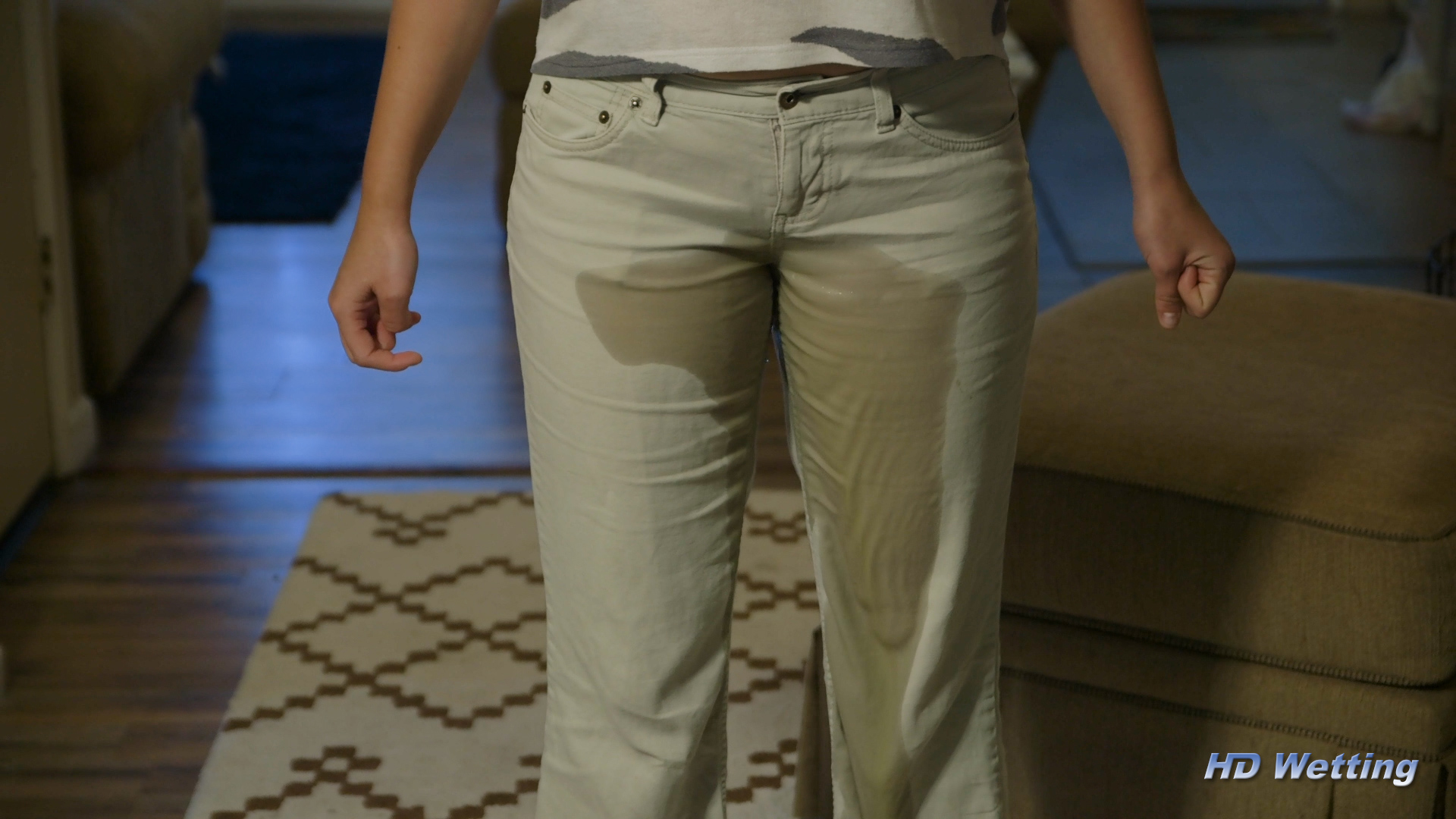 alisha-4 Fully peeing in her pants, a large wet patch extends down her legs to the floor