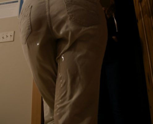 Close up from behind as Sosha pees in her khaki pants