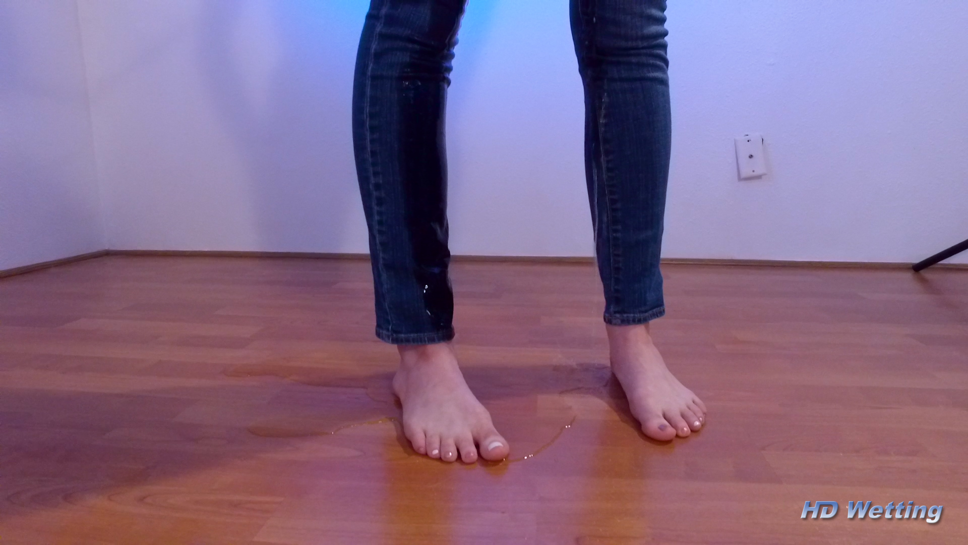slow-7 Sosha's bare feet stand in a pee puddle and a wet stain is visible on the legs of her jeans