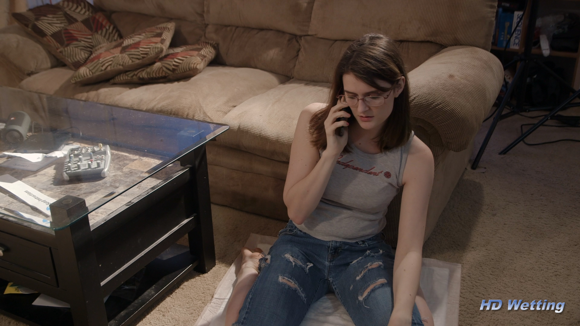 holding-5 Sosha is sitting on the floor, talking on the phone