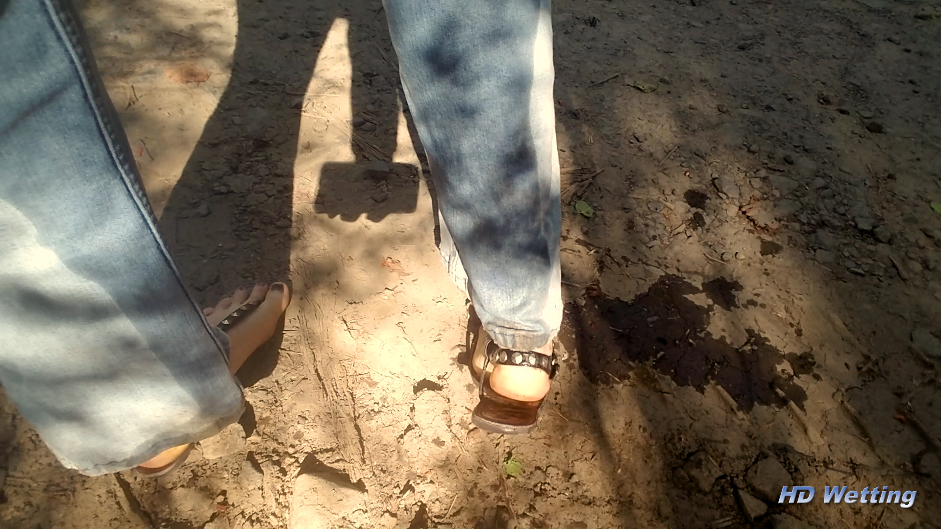 alisha-9 A view from behind of Alisha's legs shows that her pants are wet down the back and a puddle on the ground.