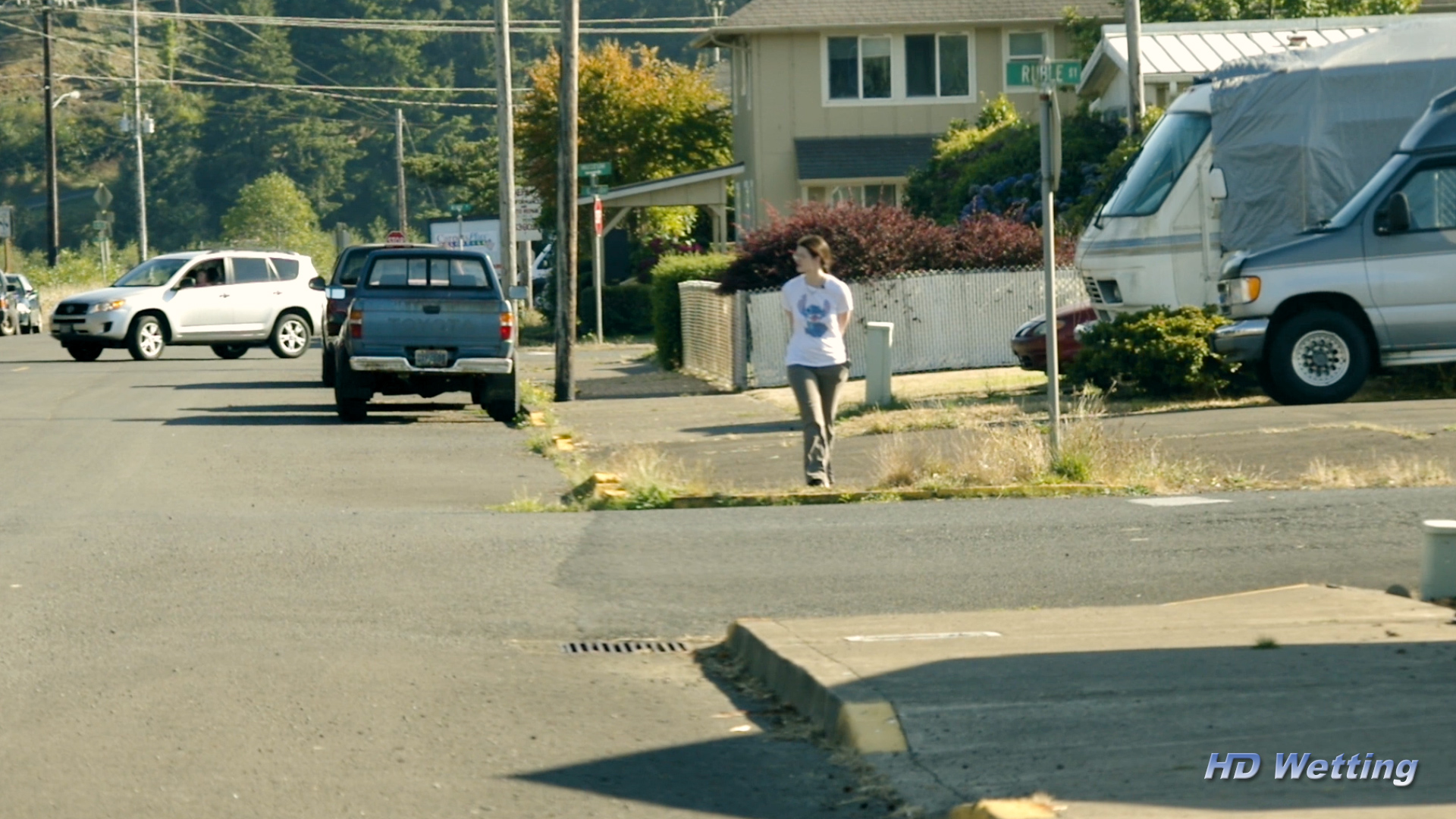 soaking-3 Sosha briskly crosses the street with her legs tightly together.