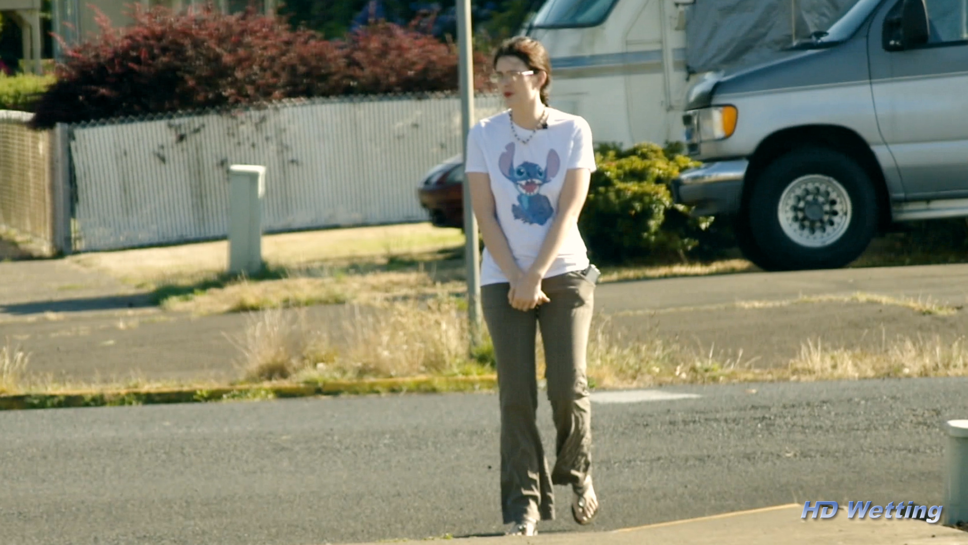 soaking-4 Tightly holding her crotch with both hands on a public street corner.