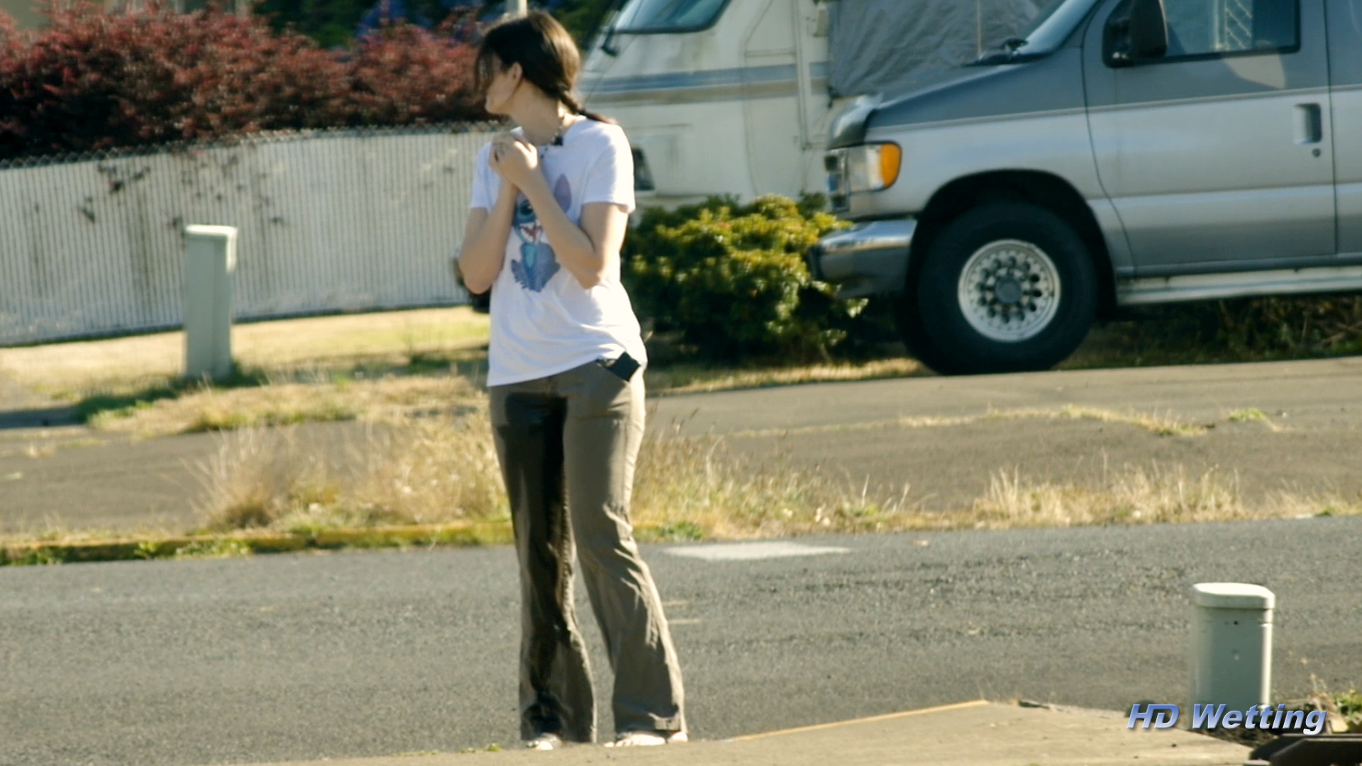 soaking-6 Sosha looks around worried, afraid someone might see as she pees in her pants in public.