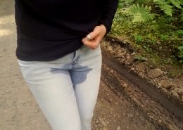 A small wet patch is visible on the front of Alisha's jeans after she accidentally leaks a little.