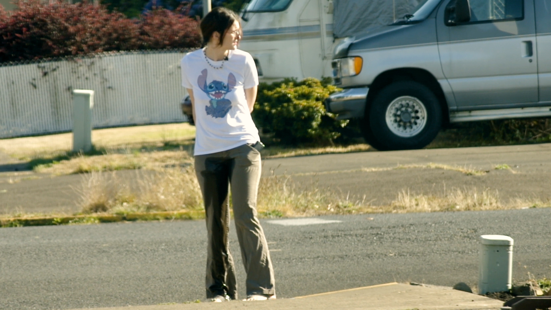 vid_863 Standing along a city street in soaking wet pants.