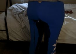 Close up of Alisha peeing in her leggings.