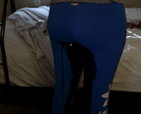 Close up of Alisha peeing in her leggings.