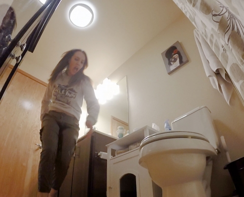 Alisha is peeing her pants while running to the toilet.