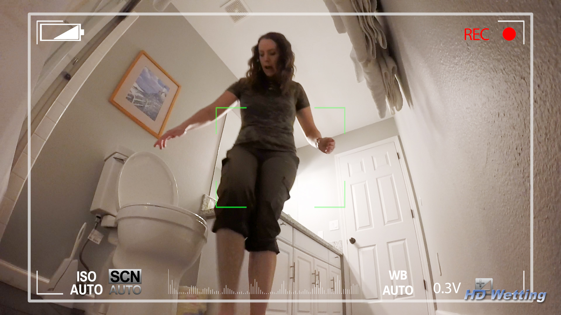 spy-2 Just in front of the toilet, Alisha's legs are pressed tightly together as she starts to wet herself.