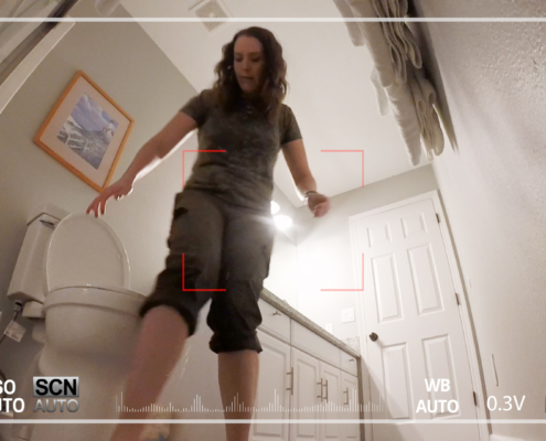Drops are visible falling from Alisha's pants just in front of the toilet.