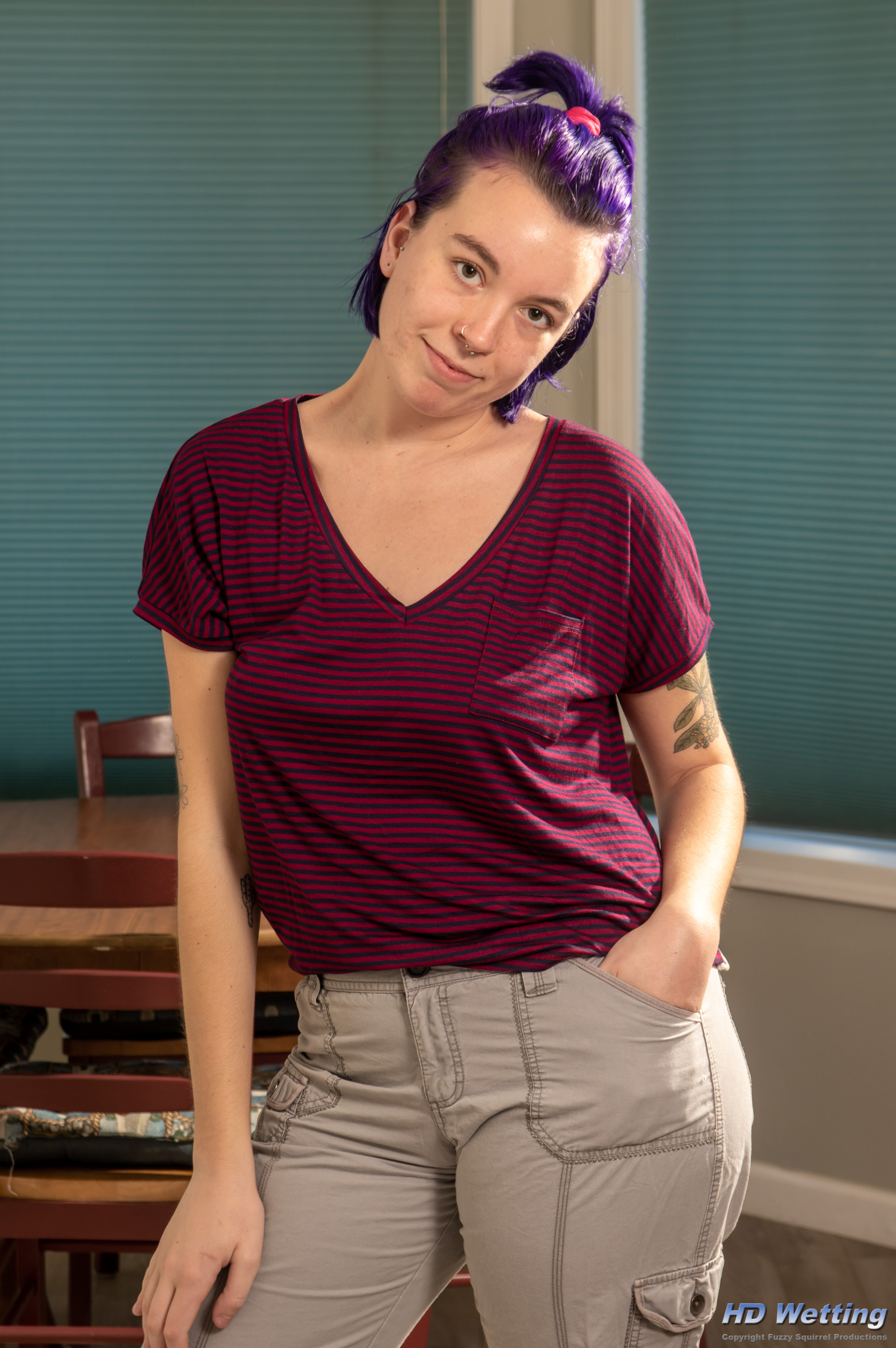 olivia-1290 Olivia poses for the camera in a striped t-shirt and light colored cargo pants.