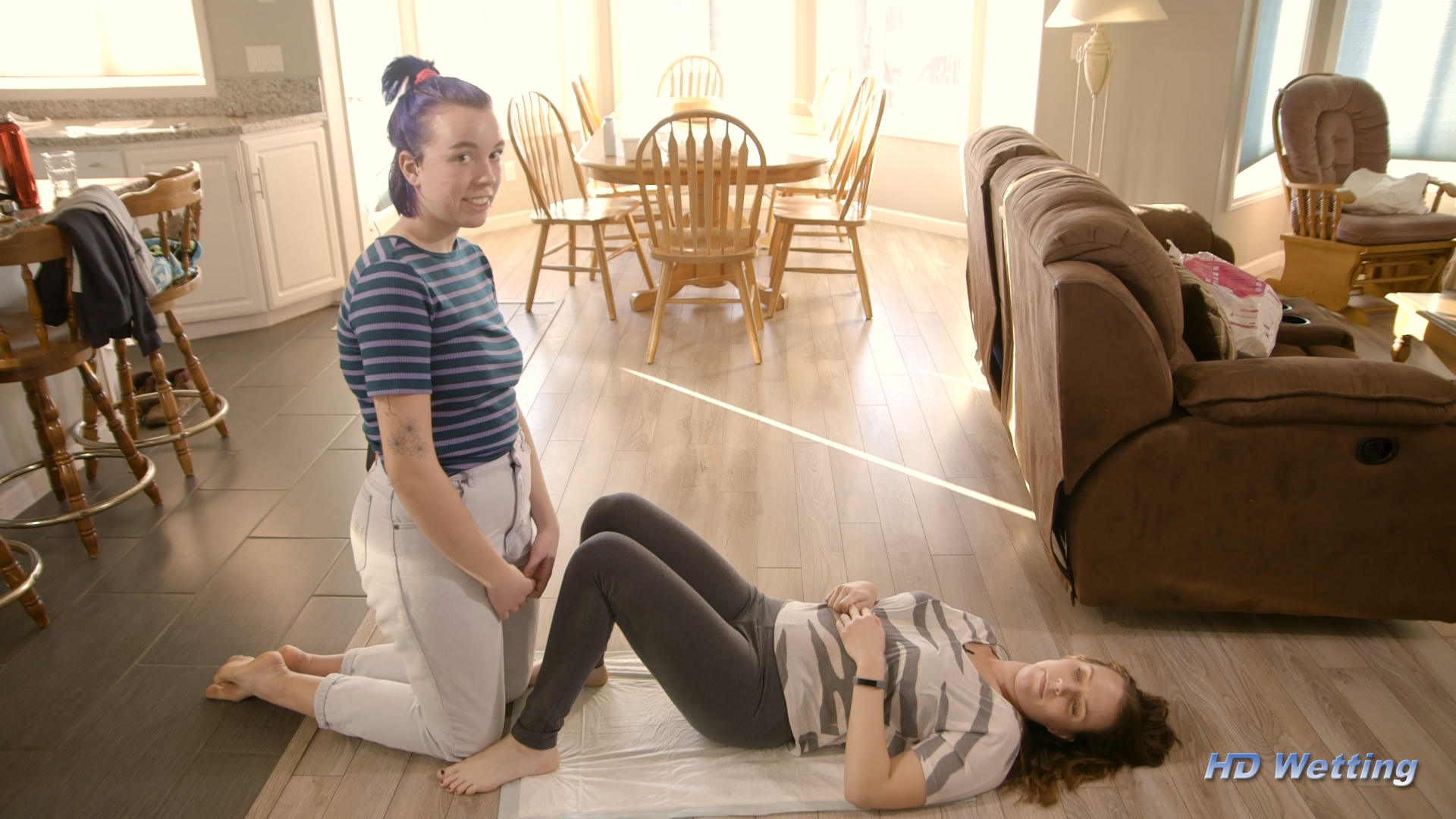 reward-1 Kneeling on the floor next to Alisha, Olivia talks to the camera.