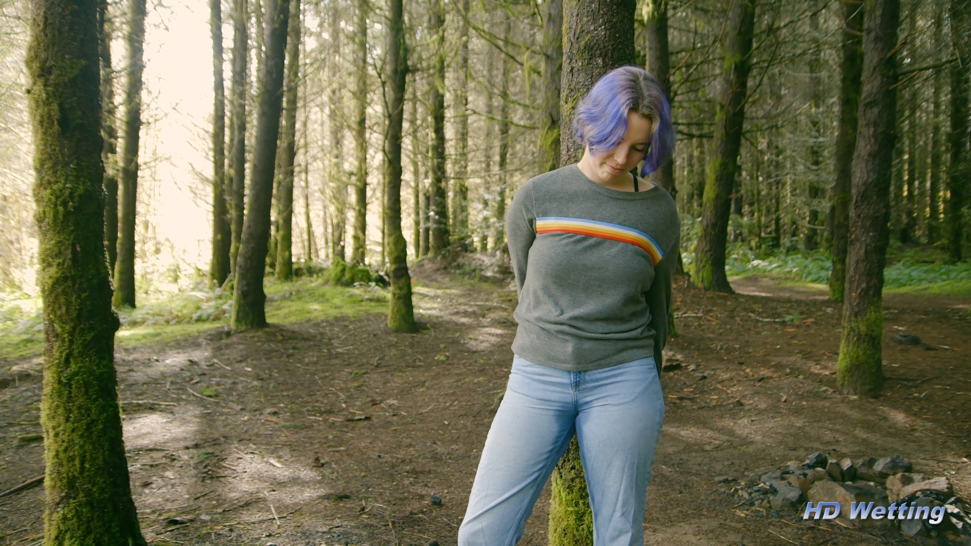bound-10 Wide shot of Olivia still tied to the tree in her wet pants.