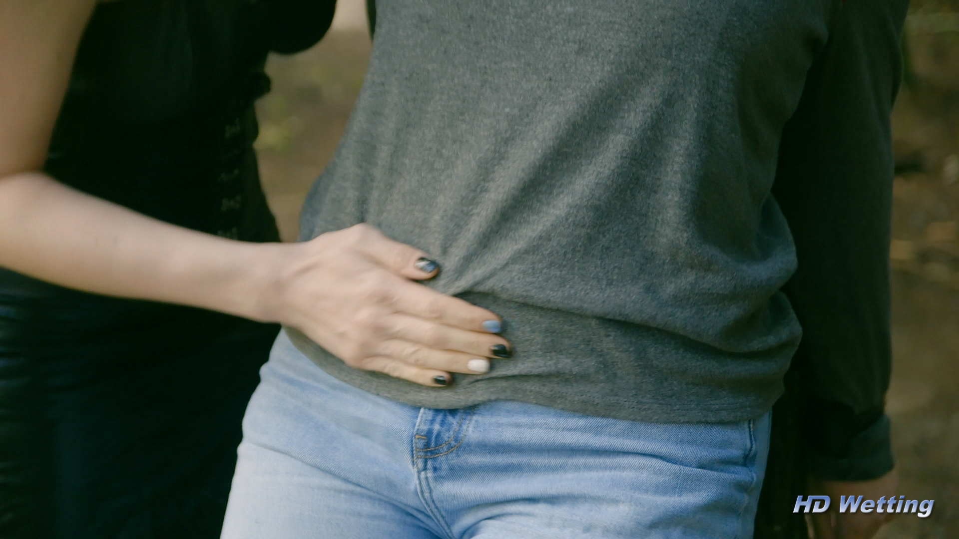bound-4 Close-up of Sosha's hands pressing on Olivia's bladder.