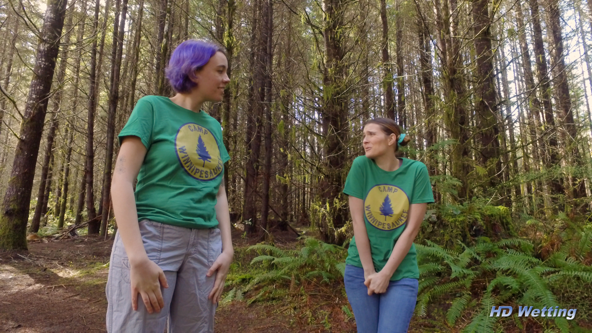 camp-3 Desperate to pee, Sosha holds her crotch as Olivia encourages her to go pee in the shrubs.